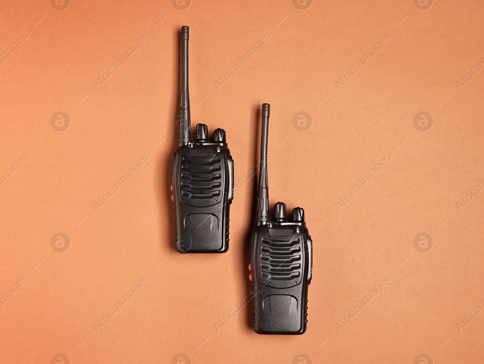 Photo of Walkie talkies on brown background, top view