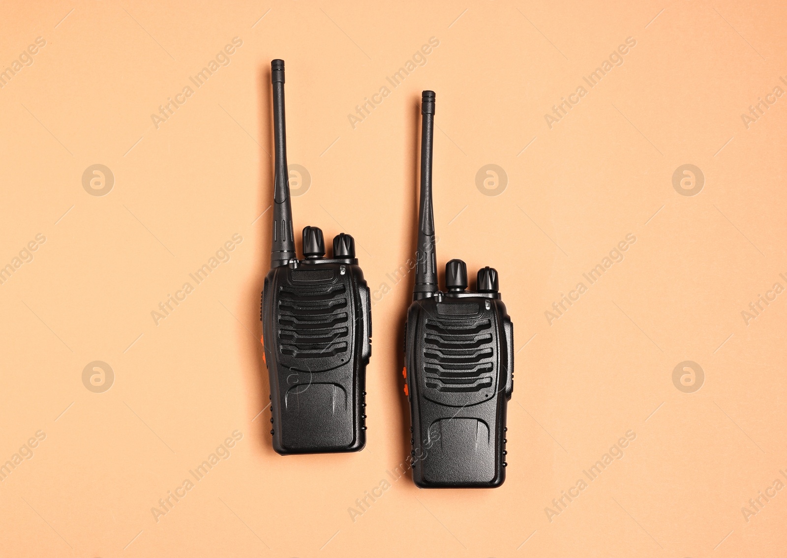 Photo of Walkie talkies on beige background, top view