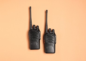 Photo of Walkie talkies on beige background, top view