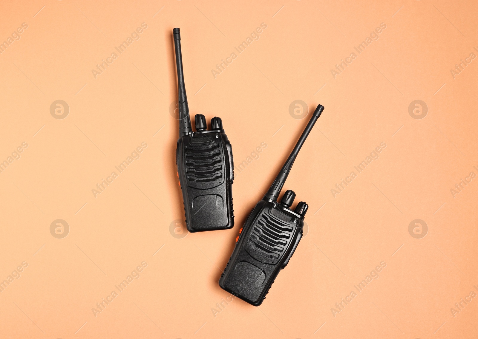 Photo of Walkie talkies on beige background, top view