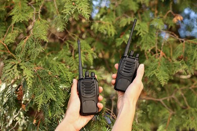 Photo of Woman with walkie talkies in park, closeup