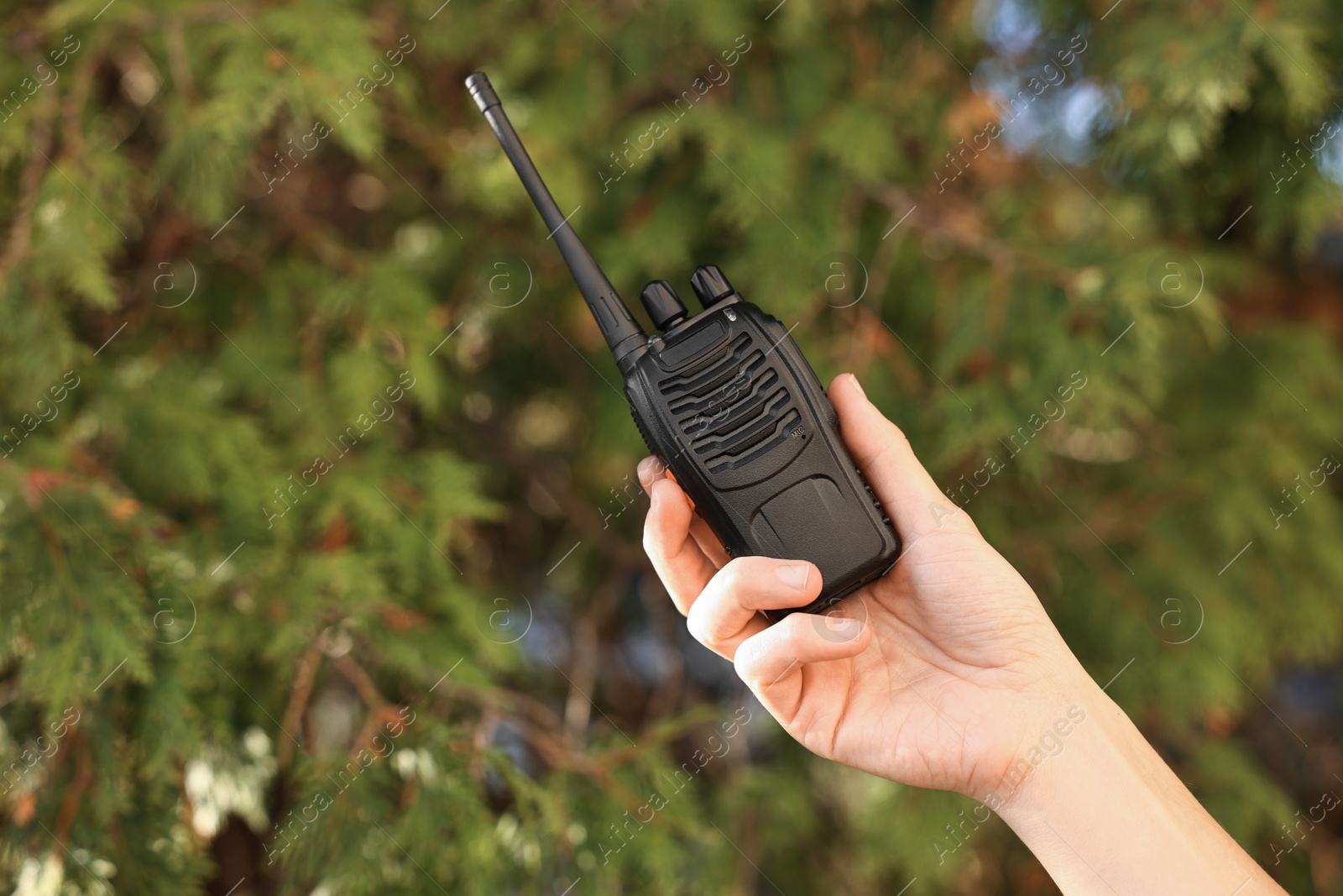 Photo of Woman with walkie talkie in park, closeup. Space for text