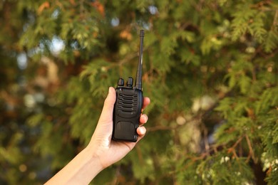 Photo of Woman with walkie talkie in park, closeup