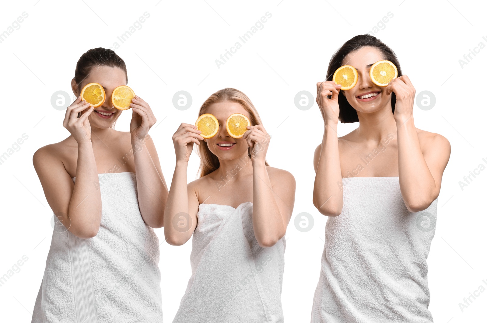 Photo of Spa day. Cheerful women wrapped in towels with orange slices on white background