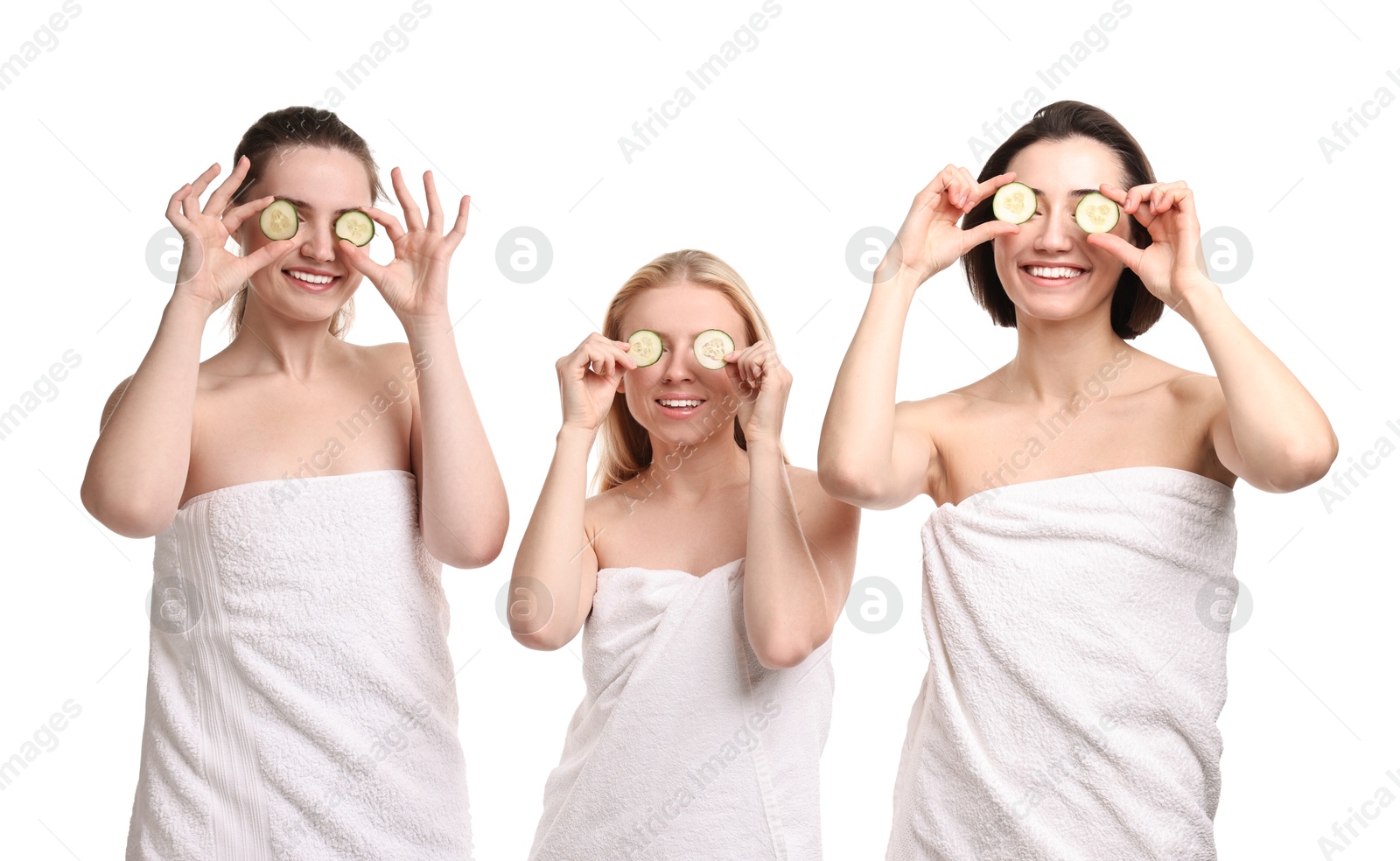 Photo of Spa day. Cheerful women wrapped in towels with cucumber slices on white background