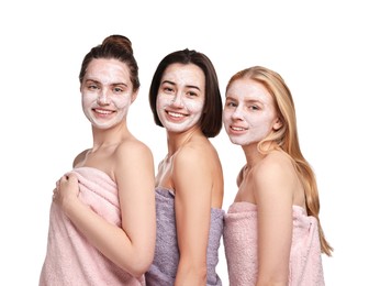 Photo of Spa day. Beautiful women with face masks wrapped in towels on white background