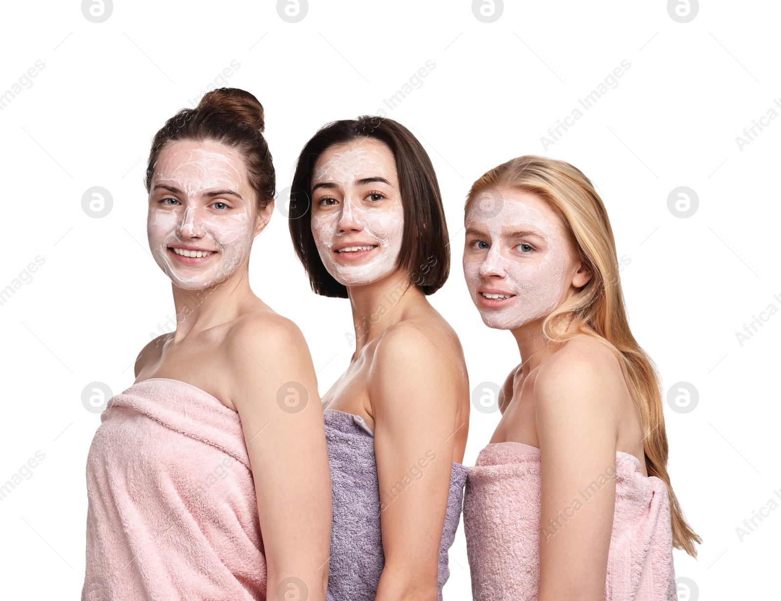 Photo of Spa day. Beautiful women with face masks wrapped in towels on white background