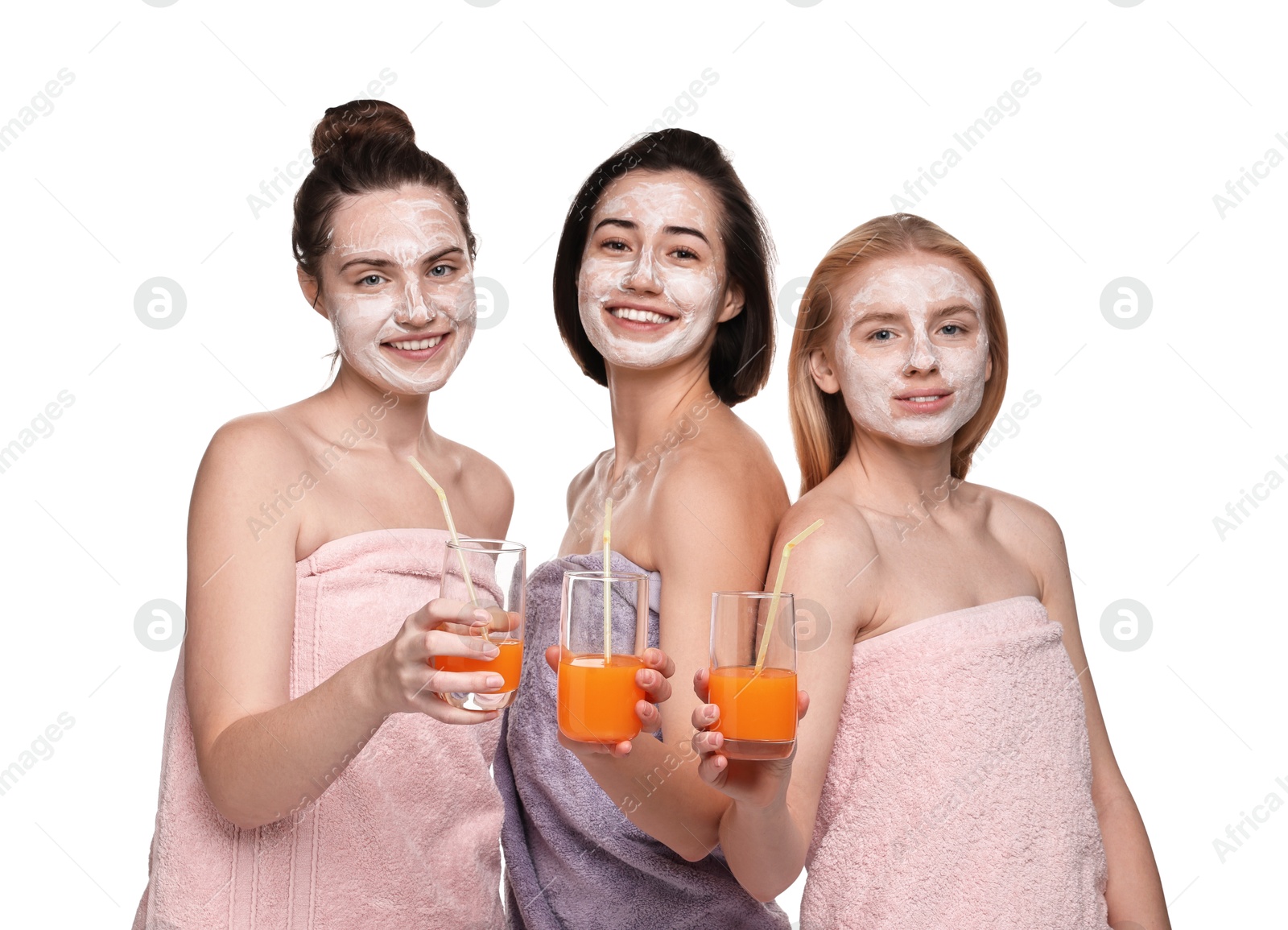 Photo of Spa day. Beautiful women with face masks and healthy drinks on white background