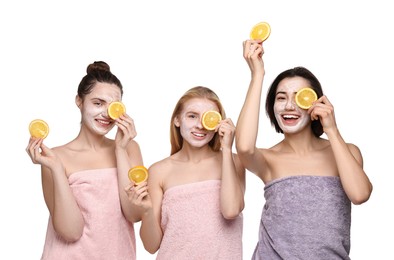 Spa day. Beautiful women with face masks and orange slices on white background