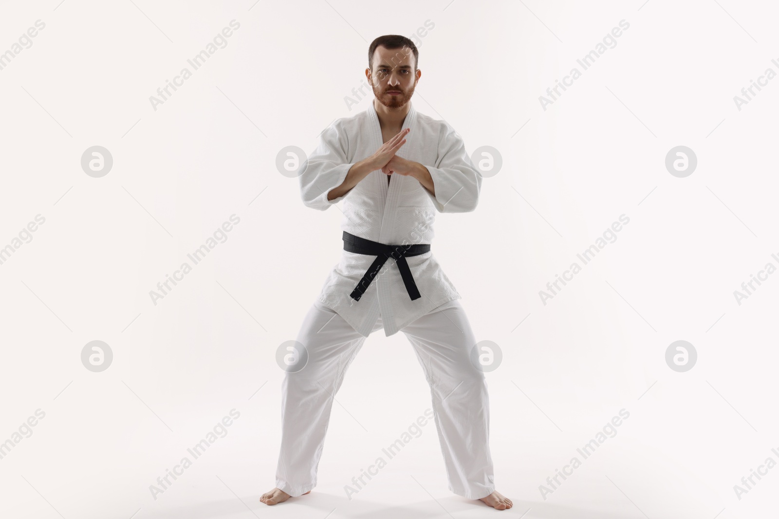 Photo of Karate fighter in uniform on white background