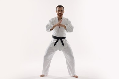 Photo of Karate fighter in uniform on white background