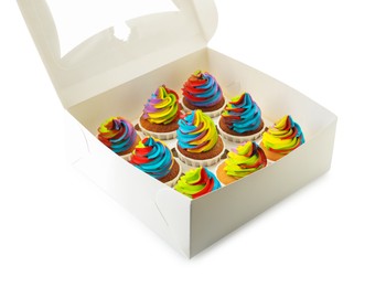 Photo of Tasty cupcakes with colorful cream in box isolated on white