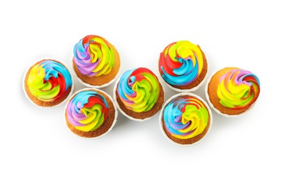 Photo of Tasty cupcakes with colorful cream isolated on white, top view