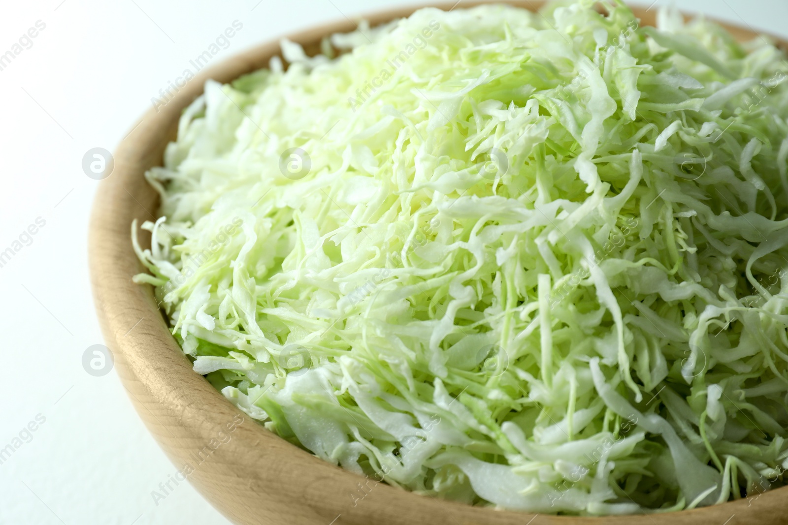 Photo of Fresh shredded cabbage on light table, closeup