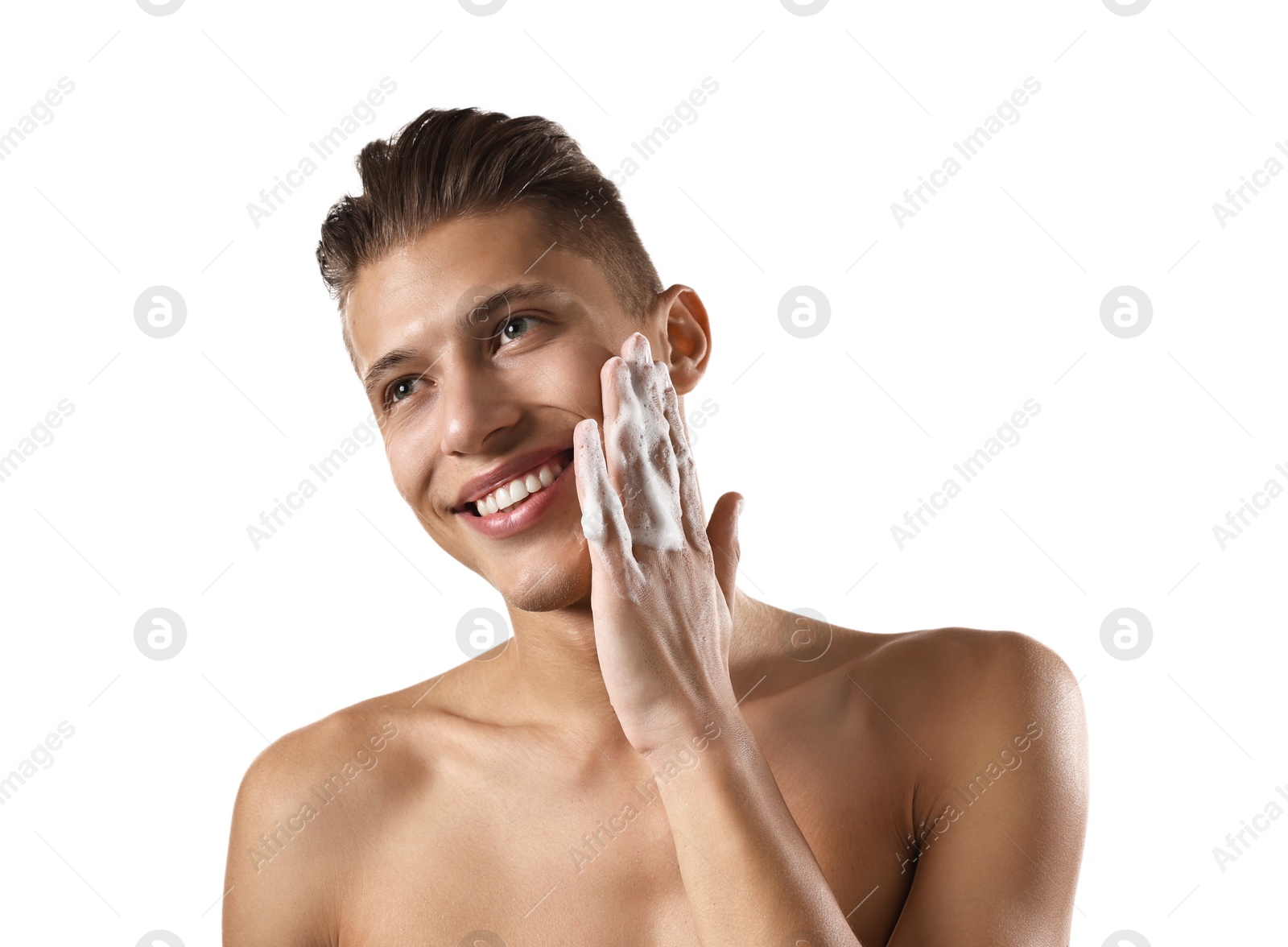 Photo of Smiling man washing his face with cleansing foam on white background