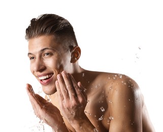 Photo of Smiling man washing his face on white background