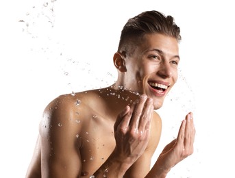 Photo of Smiling man washing his face on white background