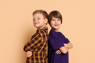 Photo of Portrait of cute brothers on beige background