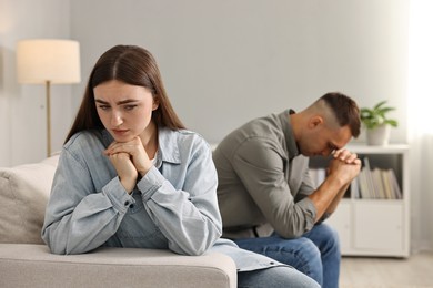 Offended couple ignoring each other at home