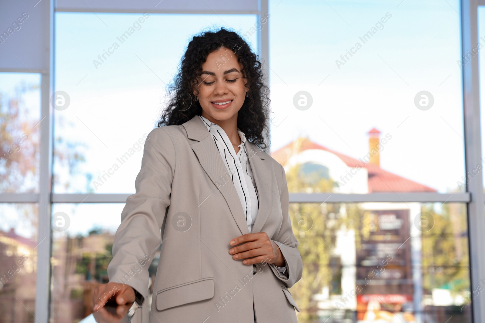 Photo of Portrait of young woman wearing stylish suit indoors