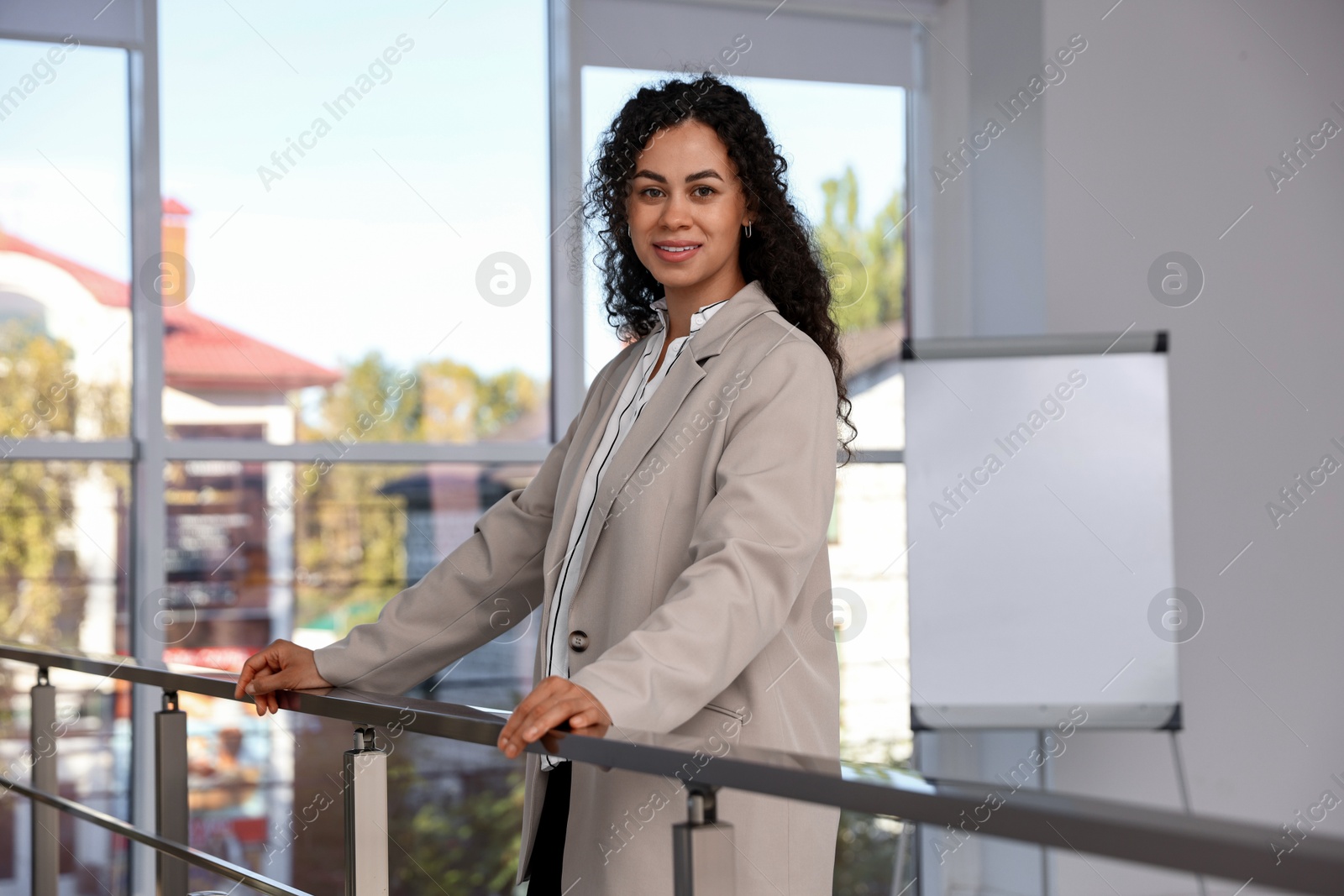 Photo of Portrait of young woman wearing stylish suit indoors