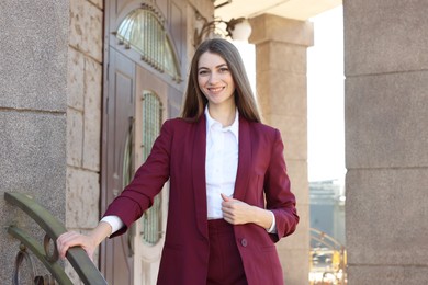 Photo of Portrait of young woman wearing stylish suit outdoors