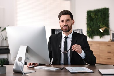 Man working on computer at table in office