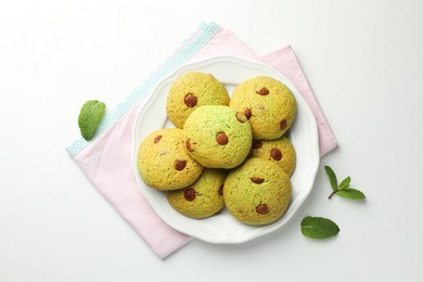 Photo of Delicious mint chocolate chip cookies on white table, top view