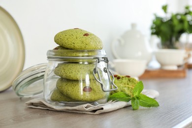 Photo of Delicious mint chocolate chip cookies on wooden table. Space for text