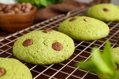 Photo of Delicious mint chocolate chip cookies on wooden table, closeup