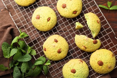 Photo of Delicious mint chocolate chip cookies on wooden table, flat lay