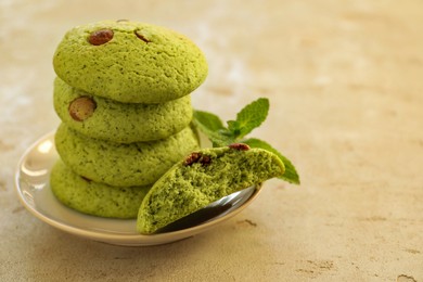 Photo of Delicious mint chocolate chip cookies on light table, closeup. Space for text