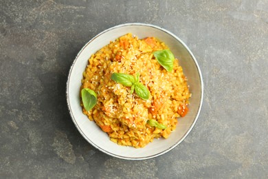 Photo of Delicious pumpkin risotto on grey table, top view
