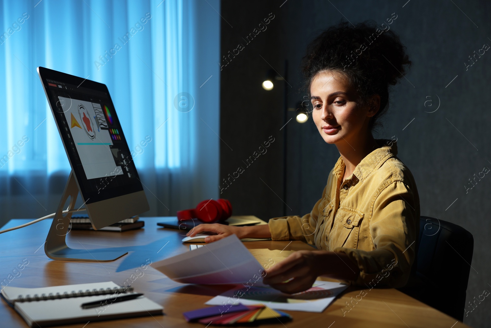 Photo of Designer with color palette working indoors at night