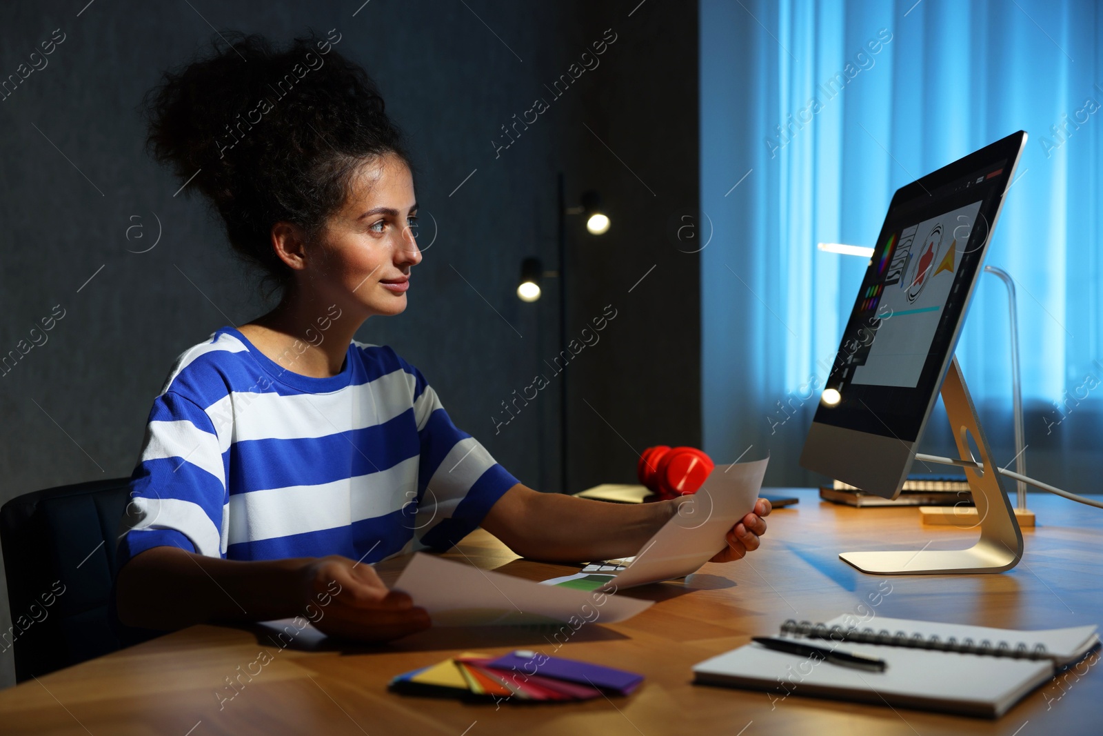 Photo of Designer with color palette working indoors at night