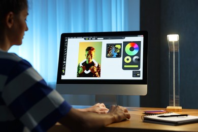 Designer working on computer indoors at night, closeup