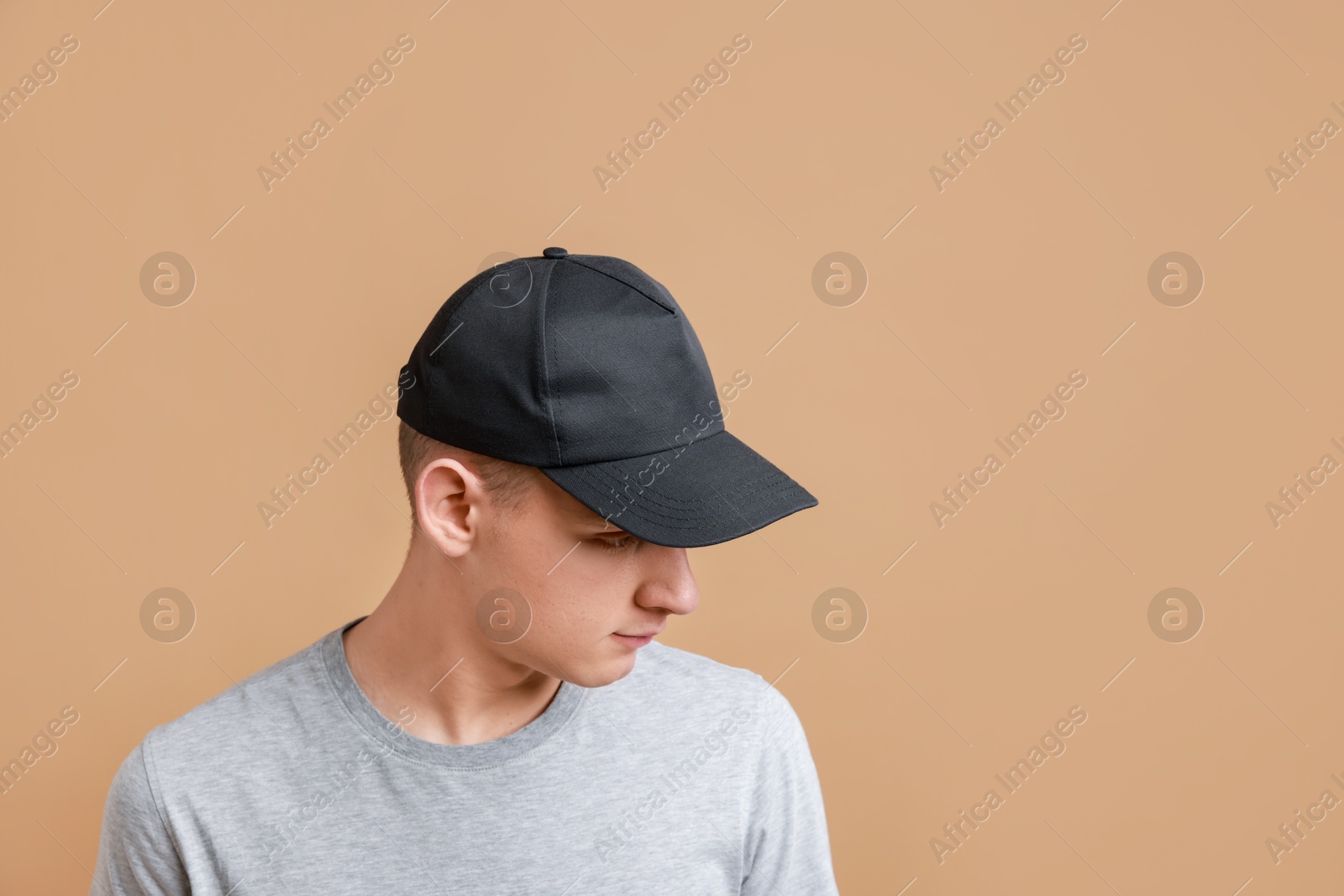 Photo of Man in stylish baseball cap on beige background. Mockup for design