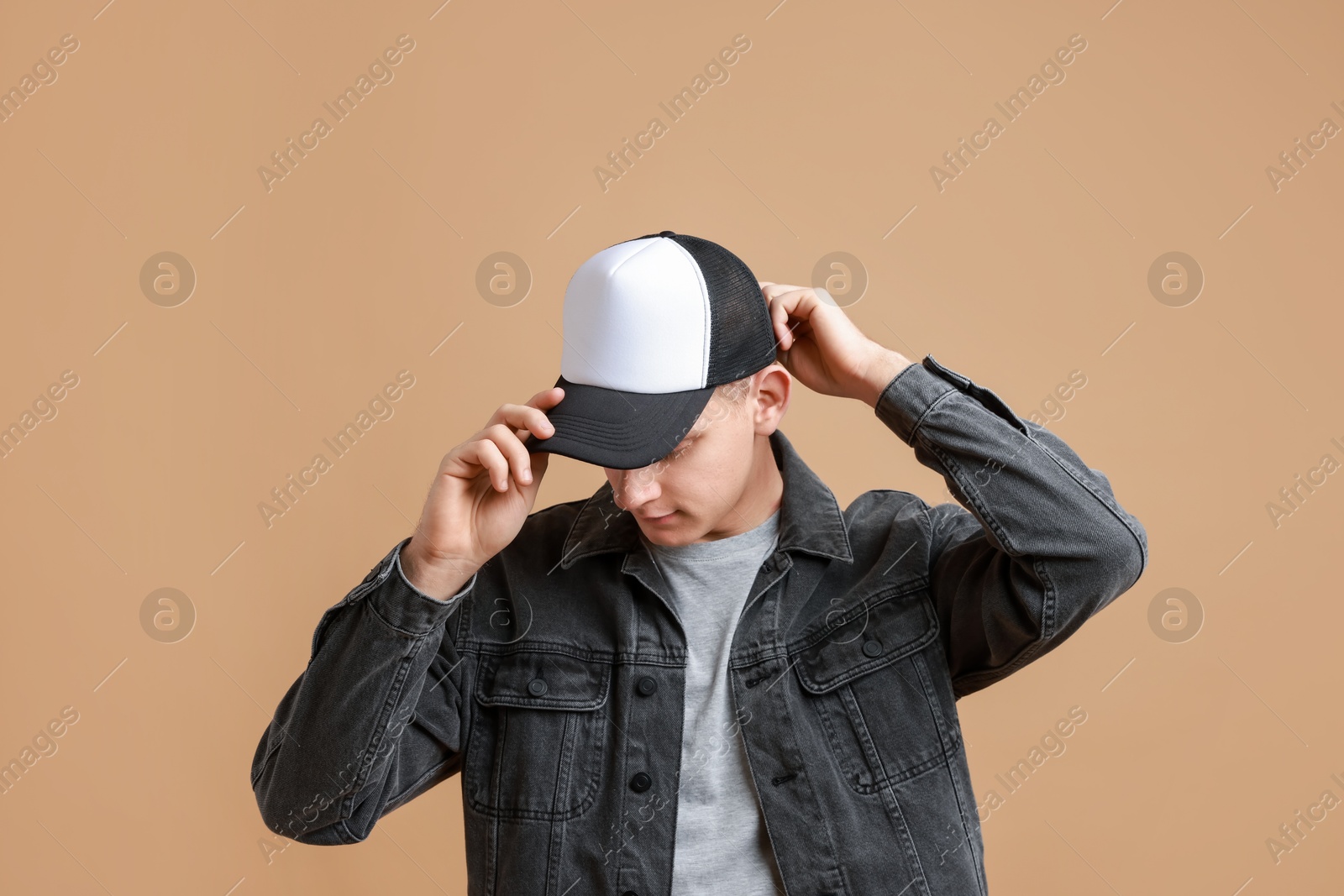 Photo of Man in stylish baseball cap on beige background. Mockup for design