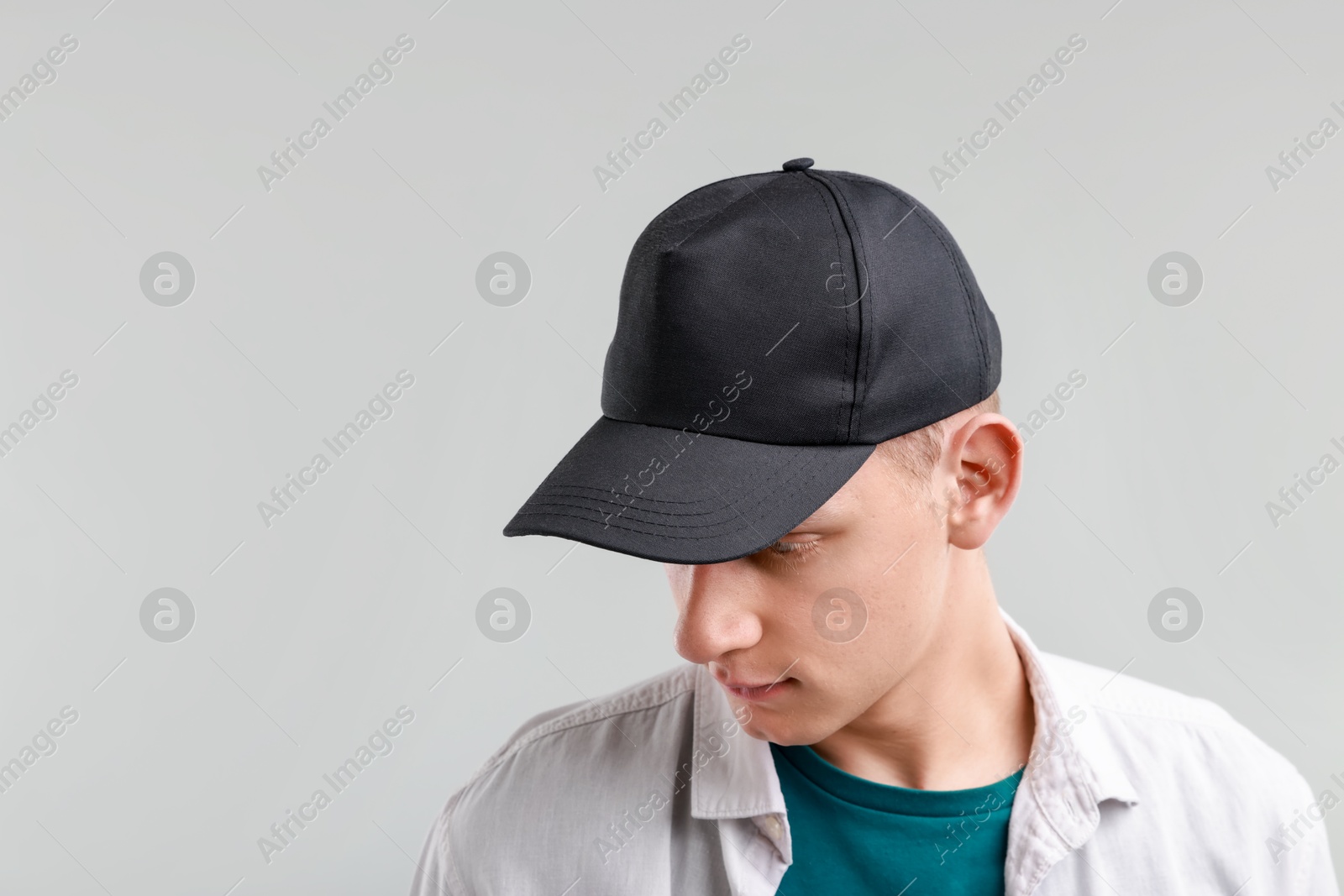 Photo of Man in stylish baseball cap on light grey background. Mockup for design