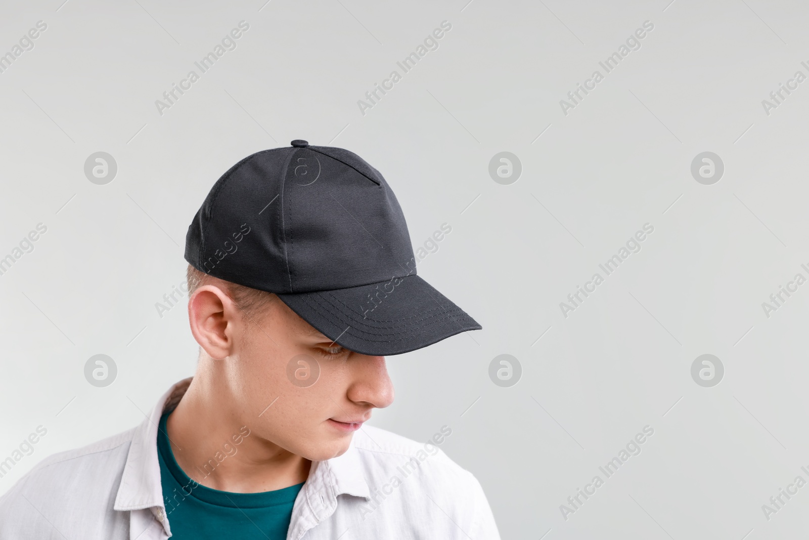 Photo of Man in stylish baseball cap on light grey background. Mockup for design