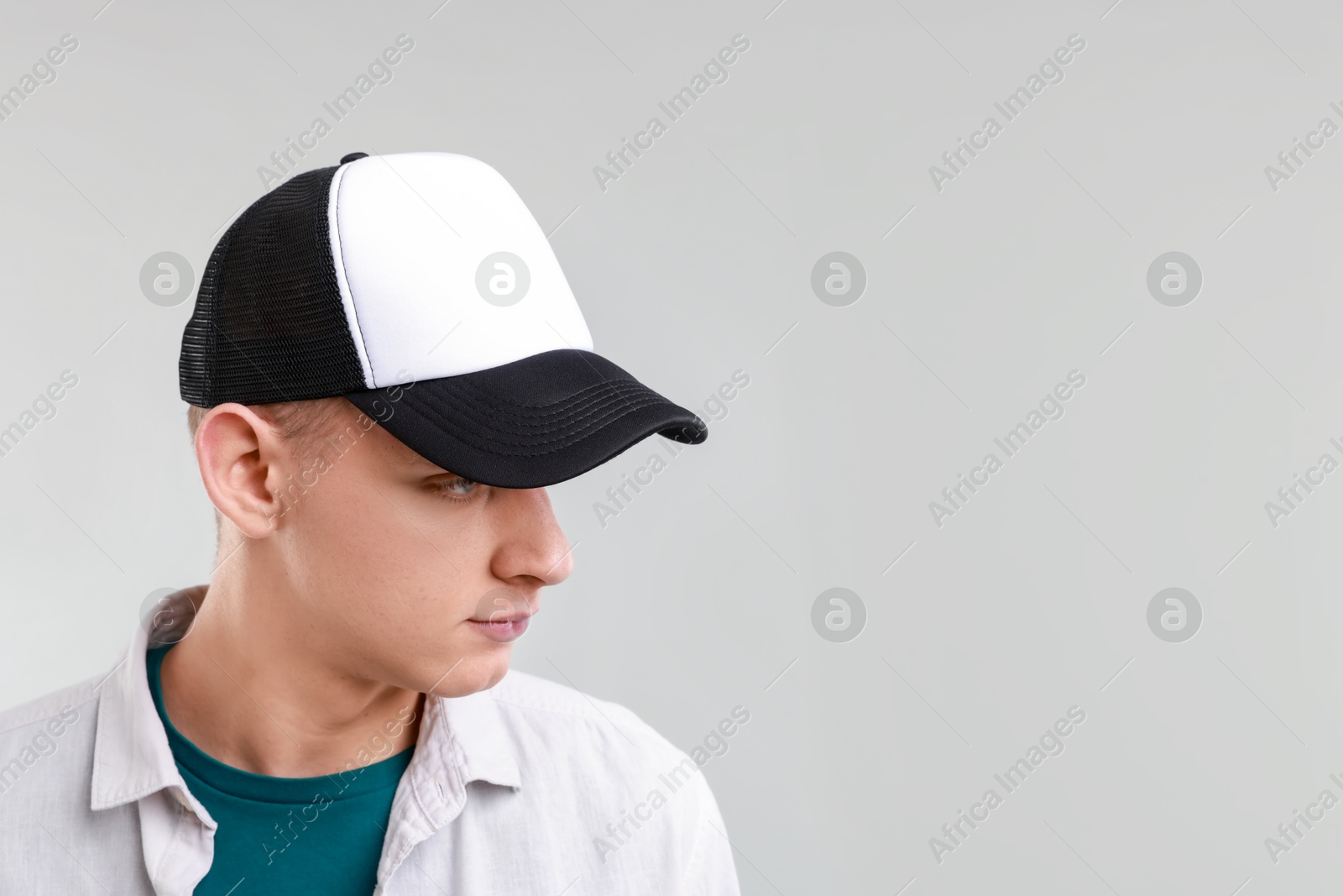 Photo of Man in stylish baseball cap on light grey background. Mockup for design