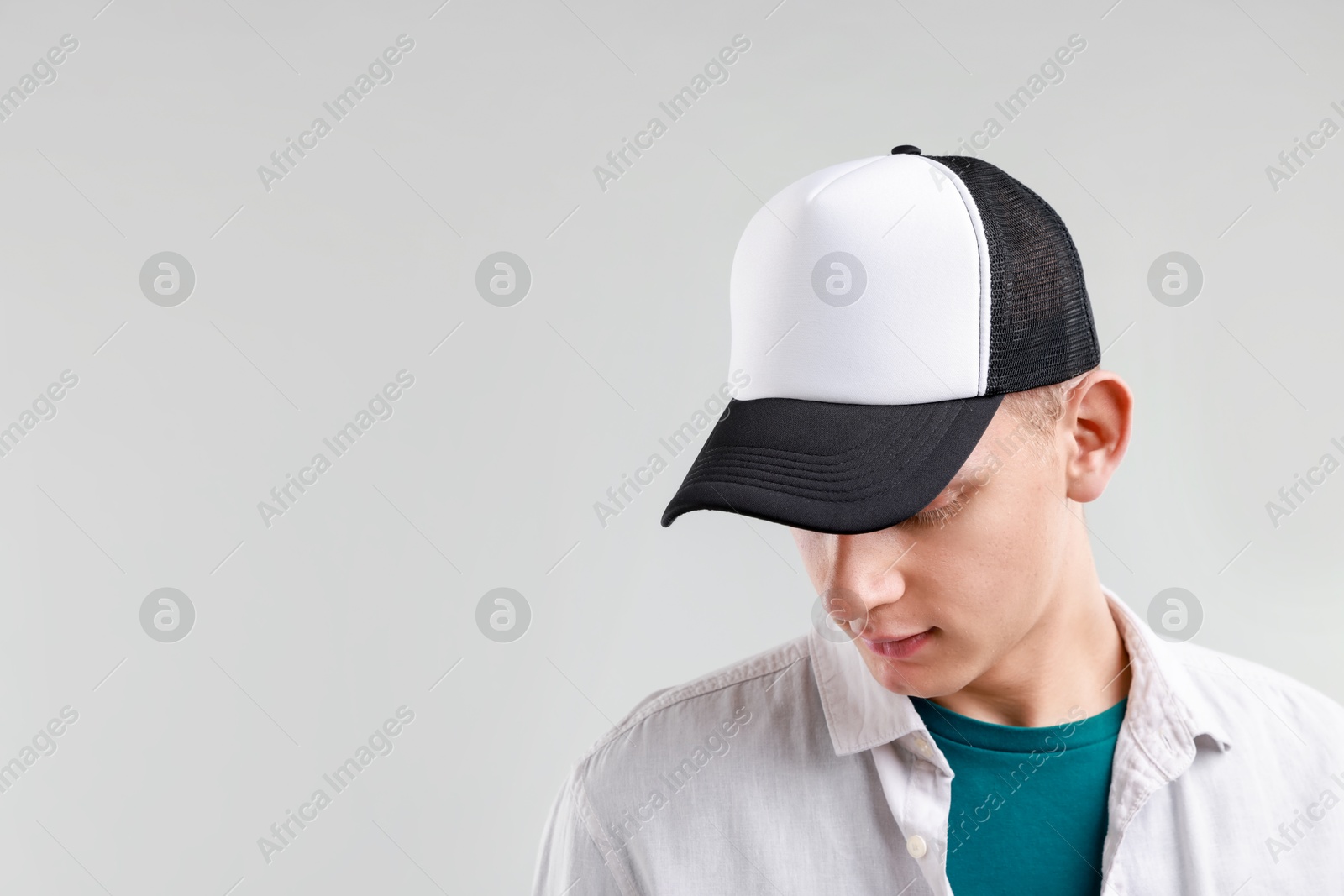 Photo of Man in stylish baseball cap on light grey background. Mockup for design