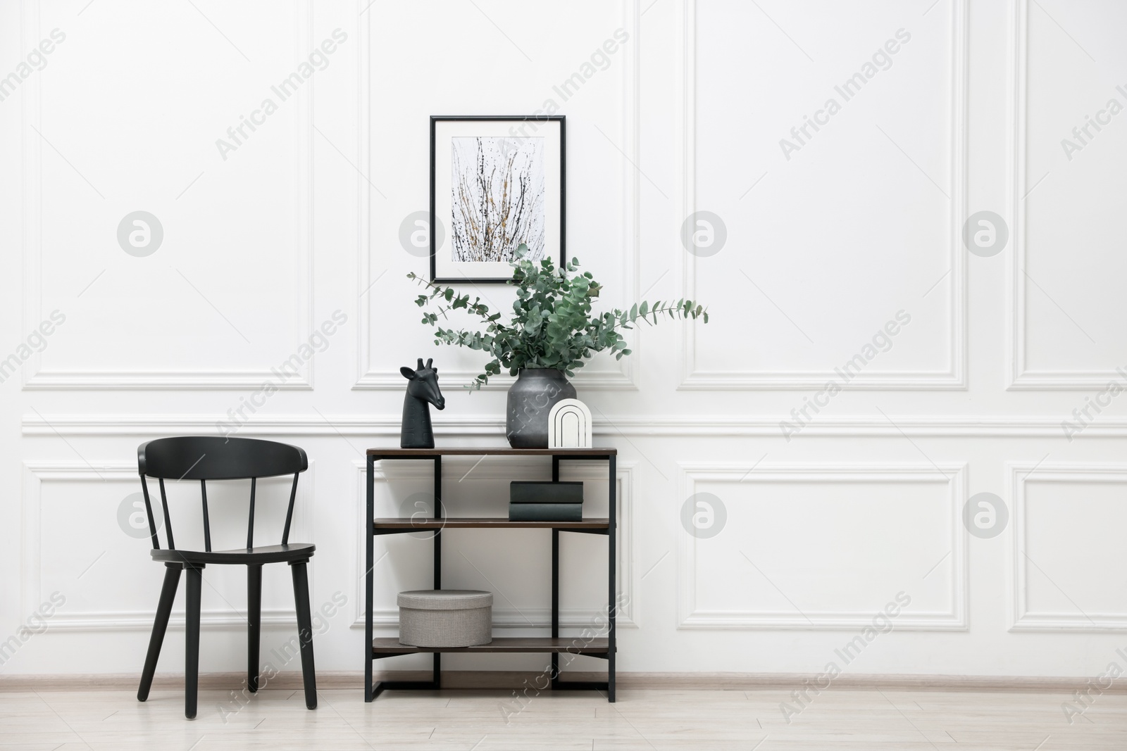 Photo of Console table with decor and chair near white wall in room, space for text. Interior design