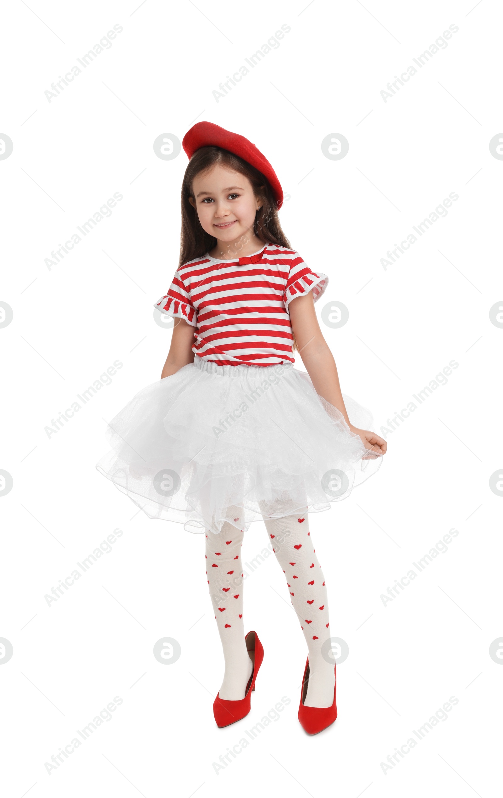 Photo of Stylish little girl wearing oversized high heeled shoes on white background