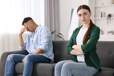 Photo of Upset woman ignoring her husband at home