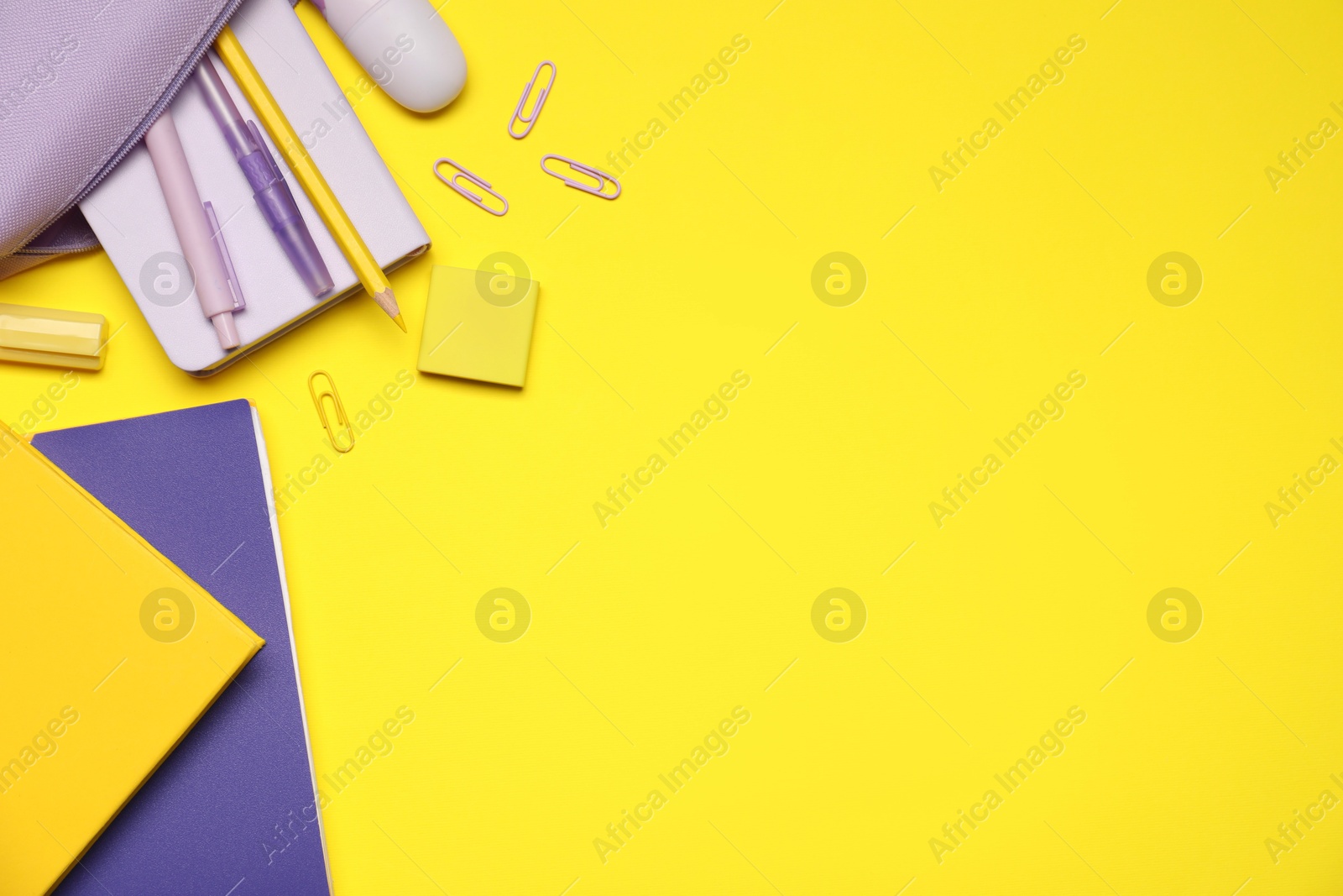 Different stationery on yellow background, flat lay. Space for text Photo of Different stationery on yellow background, flat lay. Space for text