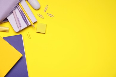 Photo of Different stationery on yellow background, flat lay. Space for text