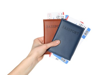 Photo of Woman holding passports with tickets on white background, closeup