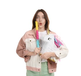 Emotional woman with unicorn shaped pinata and stick isolated on white