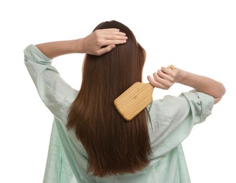 Photo of Woman brushing her hair on white background, back view